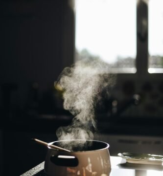 white casserole with gray spoon on black surface